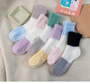 Cozy winter coral fleece colorblock socks detail shot, anti-slip grip sole, home wear.