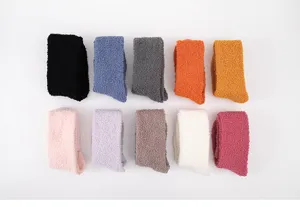 Detail shot of cozy women coral fleece fuzzy socks in multiple vibrant colors neatly arranged.