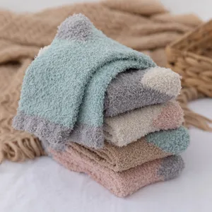 Cozy thick coral fleece sleep socks in soft color block design for winter home comfort