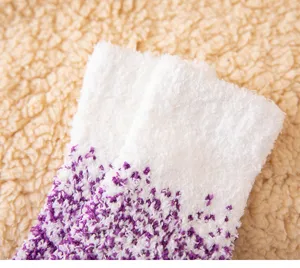 Detailed shot of cozy winter coral fleece socks featuring fluffy purple gradient texture.
