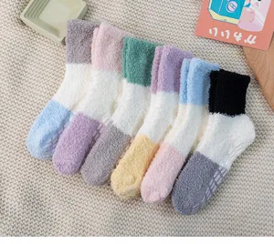 Thick fluffy coral fleece socks detail view with color block design and anti-slip sole.