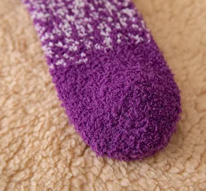Close-up detail of cozy winter fuzzy coral fleece gradient sleep sock with soft texture.