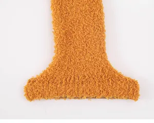 Close-up detail of soft coral fleece winter warm sleeping socks, thick cozy texture.