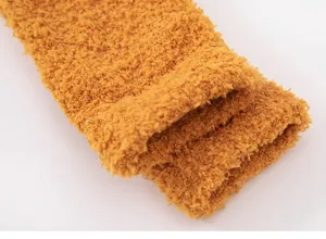 Close-up view of thick fluffy coral fleece sleep socks detail, ultra-soft texture for winter warmth.
