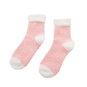 Fluffy coral fleece winter socks with pink and white color block design for cozy home sleeping warmth.