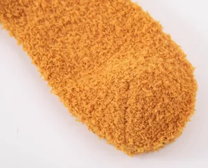 Fluffy coral fleece texture close up, thick warm winter sock detail, ginger yellow plush fabric