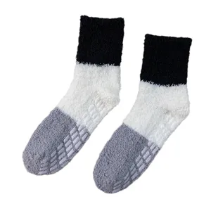 Thickened coral fleece color-blocked mid-tube socks for cozy winter indoor sleep wear.