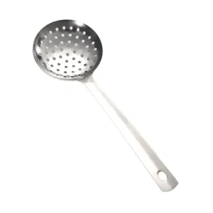 Stainless steel slotted kitchen skimmer detail, professional cooking utensil view.