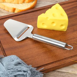 Stainless steel cheese slicer detail view kitchen tool cheese plane with ergonomic handle.