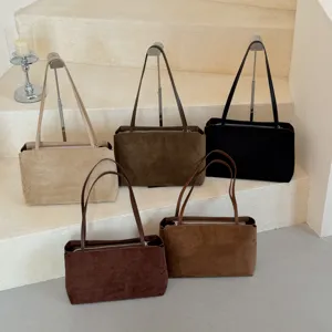 Detailed view of multiple colors suede shoulder underarm bags, minimalist commuter style.