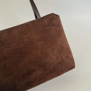 Brown suede underarm bag, retro style shoulder bag for women, chic daily commute handbag detail.