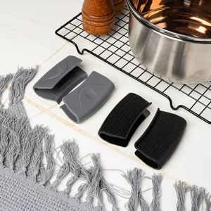 Silicone pot handle cover detail showing heat resistant grip in black and gray for cookware.