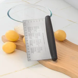 Stainless steel dough scraper and bench knife with measurement markings for baking and cooking.
