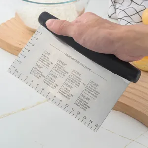 Stainless steel dough scraper with measurement conversion chart and scale for baking.