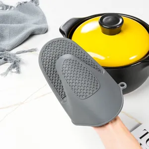 Silicone heat resistant pot holder detail view, textured anti-scald kitchen baking mitt.