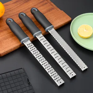 Stainless steel lemon zester and cheese grater set with ergonomic handle for kitchen use.