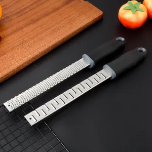 Stainless steel lemon zester and cheese grater tool with comfortable handle for kitchen.