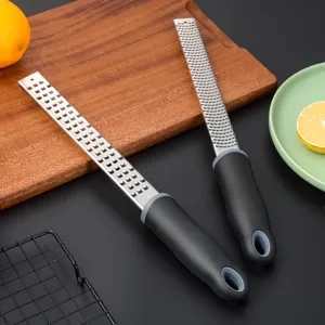 Stainless steel lemon grater and cheese zester with ergonomic handle for kitchen cooking.