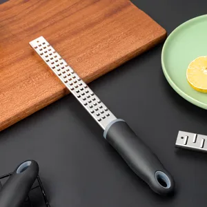Stainless steel lemon zester and cheese grater with ergonomic non-slip handle for kitchen.
