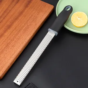 Stainless steel lemon grater detail shot, ergonomic handle for cheese and chocolate prep.