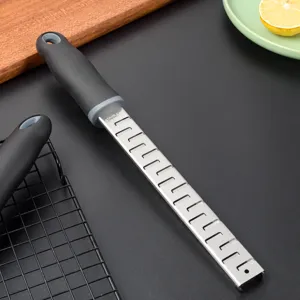 Stainless steel lemon zester and cheese grater with ergonomic non-slip handle for kitchen use.