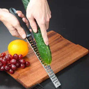 Stainless steel kitchen grater with non-slip handle for cheese, lemon, and vegetables.