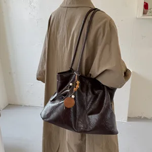 Retro large capacity tote bag for women, stylish shoulder bag with wooden pendant.