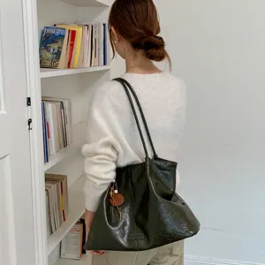 Detail view of women retro slouchy tote bag, large capacity leather shoulder bag for daily commute.