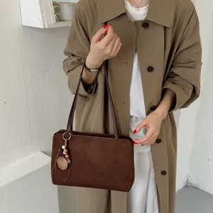 Women vintage brown suede shoulder bag detail, elegant commuter armpit bag with wood beads.