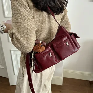 Women wine red multi-pocket shoulder bag chic PU leather commuter crossbody bag with charm.