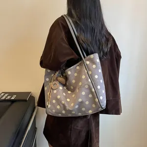 Stylish polka dot tote bag for women, large capacity shoulder bag for commuting and casual wear.