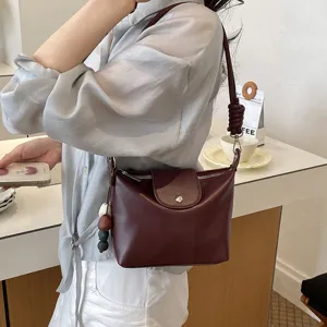 Retro versatile solid color leather shoulder bag for women, chic commuter crossbody daily bag.