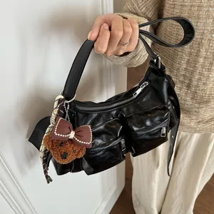 Black multi-pocket PU leather shoulder bag for women, trendy commuter crossbody bag with bear charm.