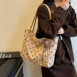 Chic polka dot canvas tote bag for women, large capacity shoulder commuting handbag detail.