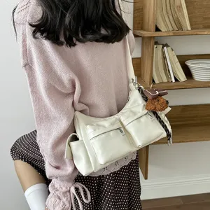 Women's multi-pocket shoulder bag casual stylish crossbody bag with cute bear charm.