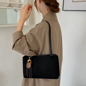 Classic black underarm shoulder bag for women, minimalist vintage style with chic charm.