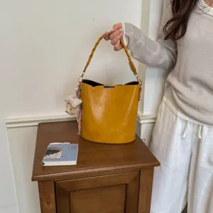Sac seau jaune vintage pour femme, élégant sac à main en cuir PU avec poignée tressée.