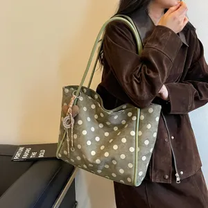 Stylish green polka dot tote bag detail, casual large capacity shoulder bag for daily commute.