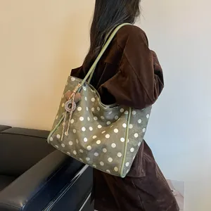 Detail view of the stylish green polka dot tote bag, large capacity shoulder bag for women.