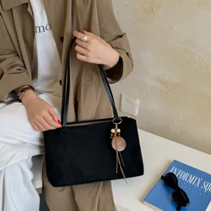 Black suede underarm bag detail, retro style single shoulder tote bag for women commuting style.