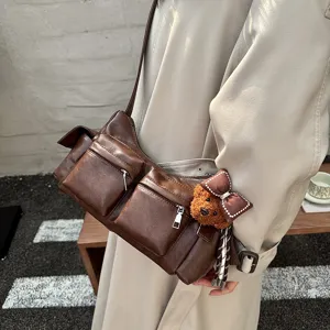 Brown multi-pocket crossbody bag with cute bear pendant for women autumn daily commute style