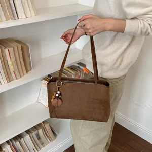 Brown suede shoulder bag detail, vintage underarm tote bag for daily commute, chic look.