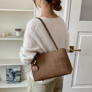 Brown suede shoulder underarm bag detail, vintage retro commuter handbag, elegant daily tote.