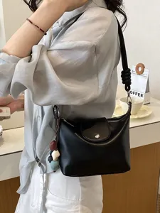 Black PU leather shoulder bag for women, retro crossbody bag with knotted strap and chic charm.