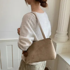 Detailed view of women khaki suede shoulder bag, vintage underarm bag for daily commute.