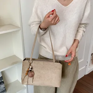 Retro suede underarm shoulder bag for women, elegant daily commute tote with chic wooden charm.