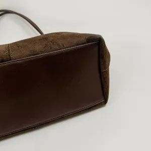 Brown suede and leather tote bag detail view showing premium texture and craftsmanship for women.