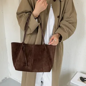 Brown suede tote bag for women, retro commuter shoulder bag with stylish knotted strap design.