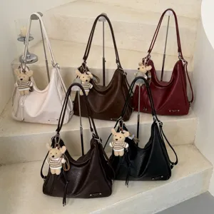 Large capacity PU leather tote bag with cute bear pendant, versatile shoulder bag for women.