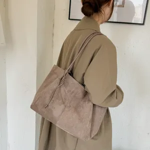 Detailed view of the women's vintage faux suede shoulder tote bag with knotted strap design.